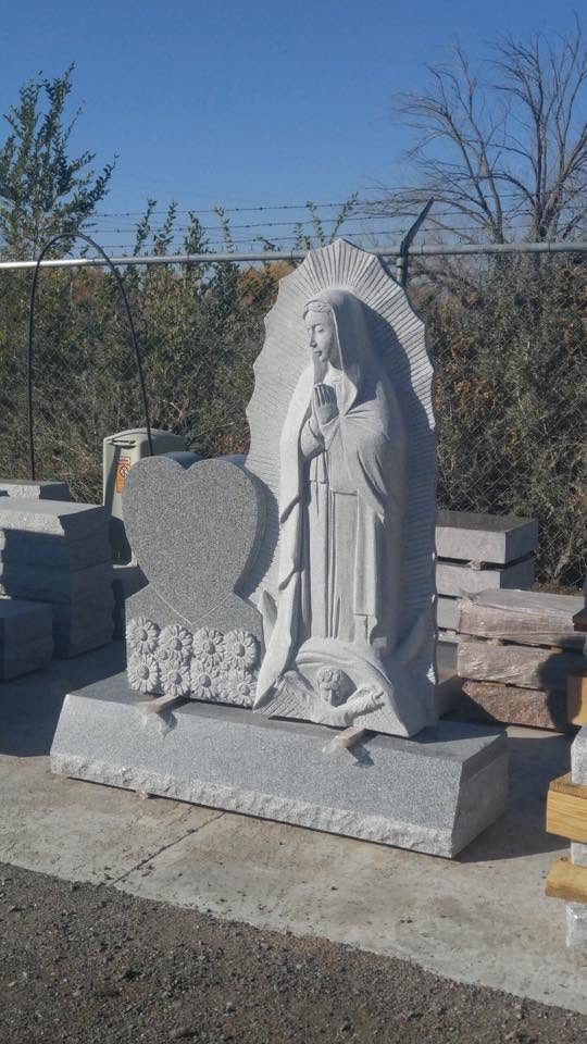 Gray granite Our Lady of Guadalupe sculpture monument with heart tablet and carved daisy base