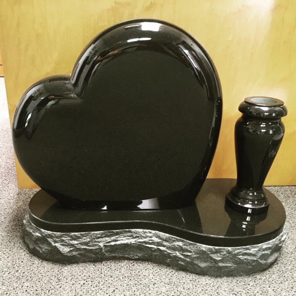 Polished black granite heart monument with matching granite vase on a rough-cut companion base