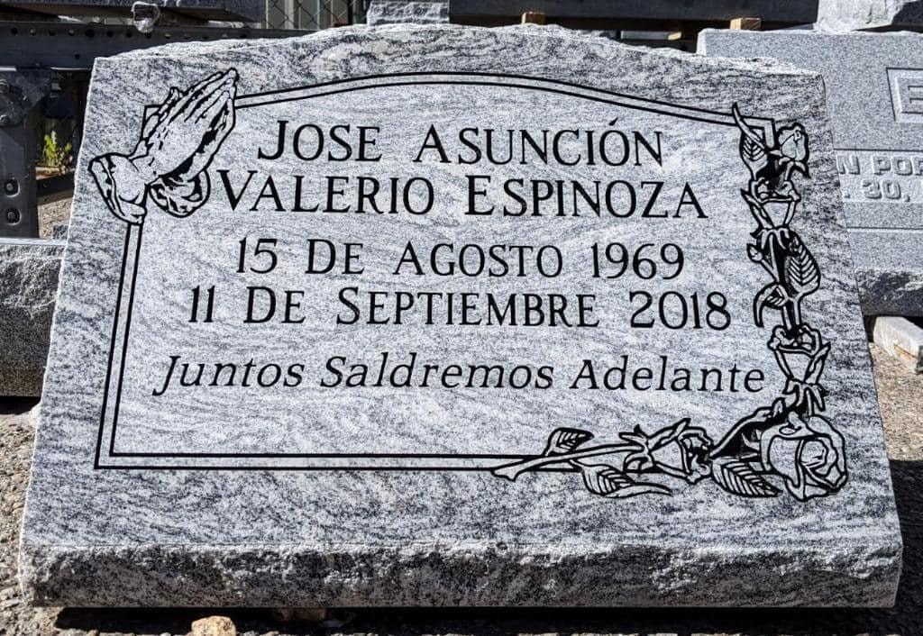 Jose Asuncion Valerio Espinoza gray granite slant with engraved praying hands, roses, and 'Juntos Saldremos Adelante' inscription