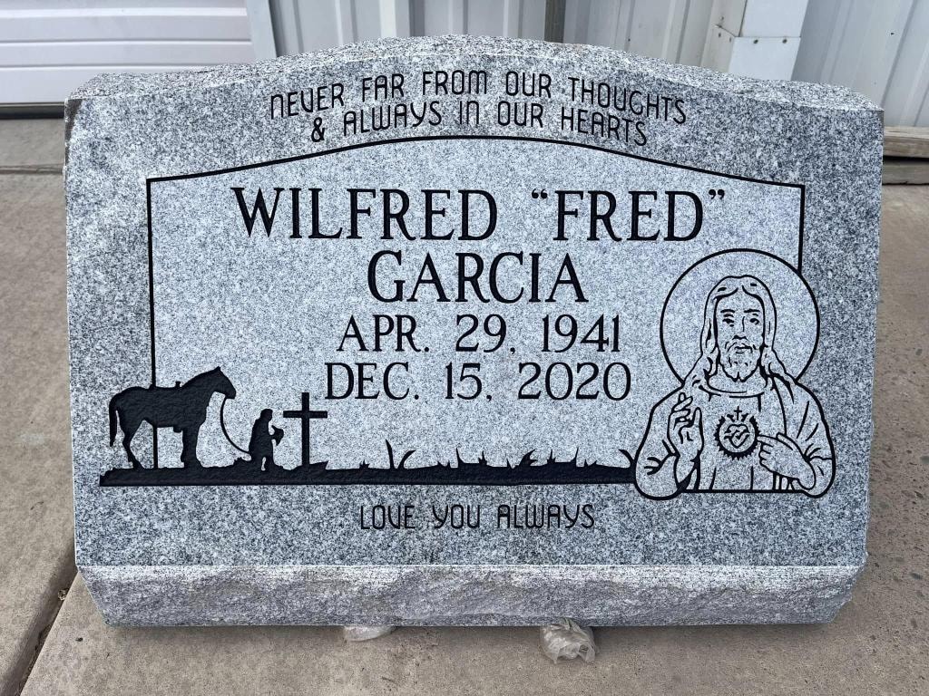 Wilfred 'Fred' Garcia gray granite slant with engraved kneeling figure, horse, cross, Sacred Heart of Jesus, and 'Love You Always' inscription
