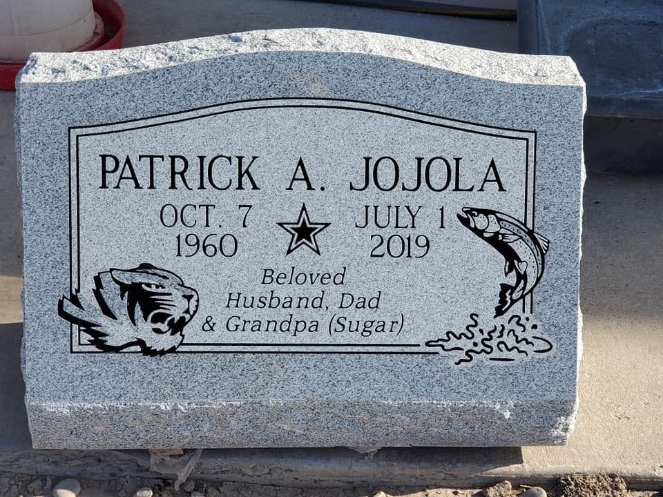 Patrick A. Jojola gray granite slant with engraved tiger, leaping fish, star, and "Beloved Husband, Dad & Grandpa" inscription