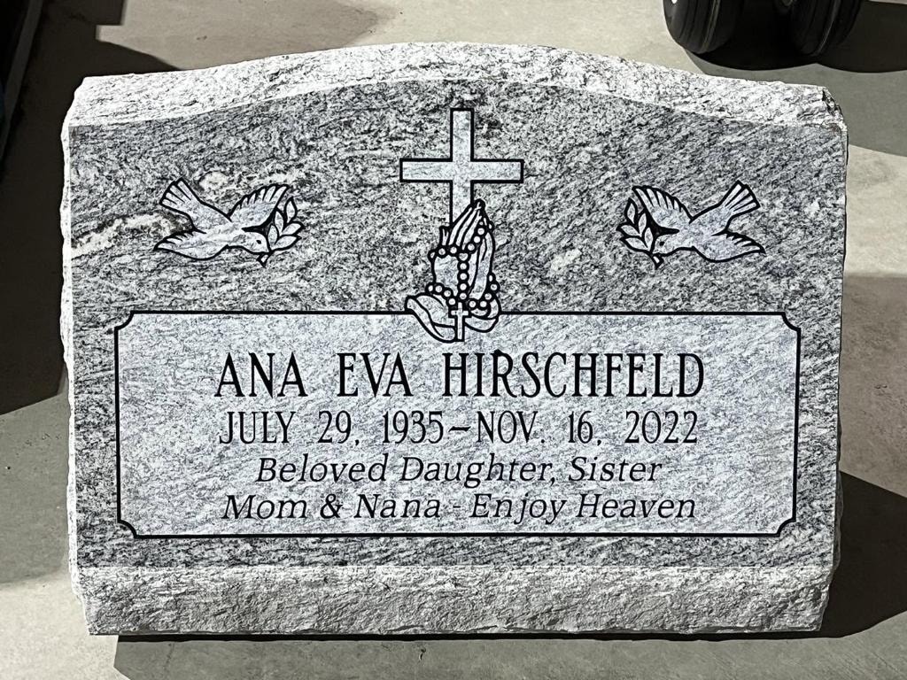 Ana Eva Hirschfeld gray granite slant with engraved cross, praying hands with rosary, doves, and Beloved Daughter Sister Mom and Nana inscription