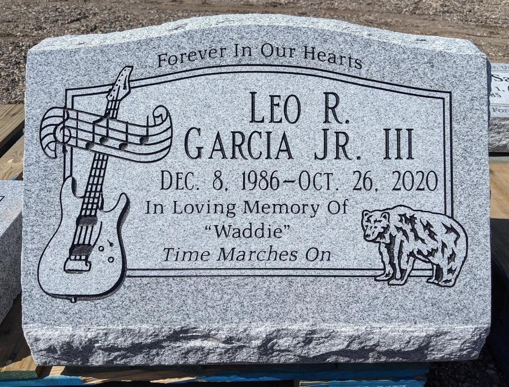 Leo R. Garcia Jr. III gray granite slant with engraved guitar musical notes and bear Forever In Our Hearts Time Marches On inscription