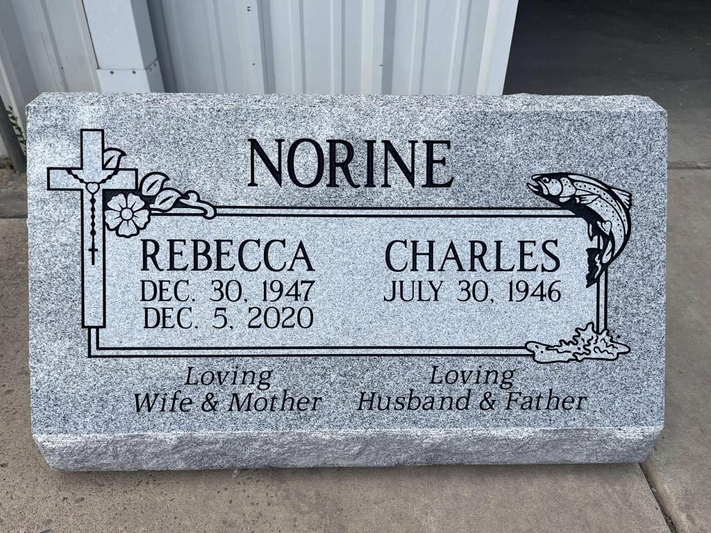 Rebecca and Charles Norine gray granite companion slant with engraved cross, flowers, leaping trout, and Loving Wife and Mother Loving Husband and Father inscription