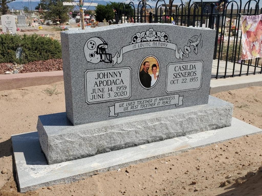 Apodaca and Sisneros gray granite companion upright monument with football helmet engraving, couple portrait photo tile, and rough-cut base