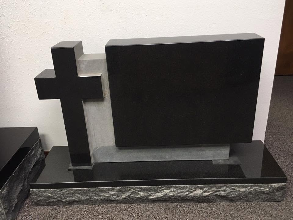 Black granite cross block display monument with polished tablet and rough-cut base