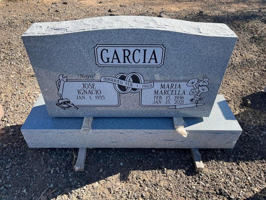 Garcia gray granite companion upright monument with wedding rings engraving, mechanic tools, and floral motif for Jose Ignacio and Maria Marcella Garcia