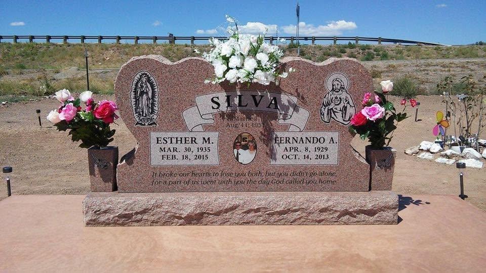 Silva family red granite companion upright monument with Our Lady of Guadalupe and Sacred Heart engravings, couple portrait photo tile, companion vases with roses, for Esther M. and Fernando A. Silva
